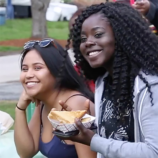 Two students outdoors smiling