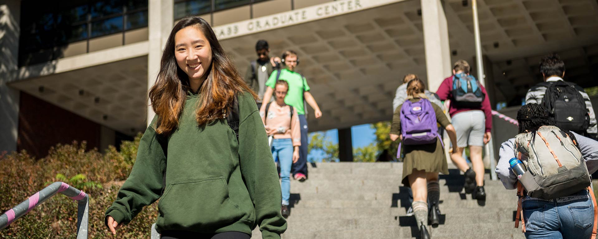 Students outdoors walking up and down the Rabb Steps