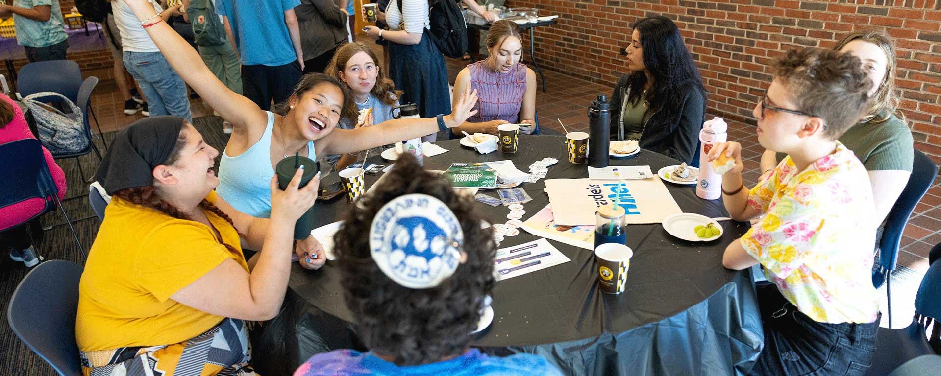 Students sitting around a table at Hillel breakfast