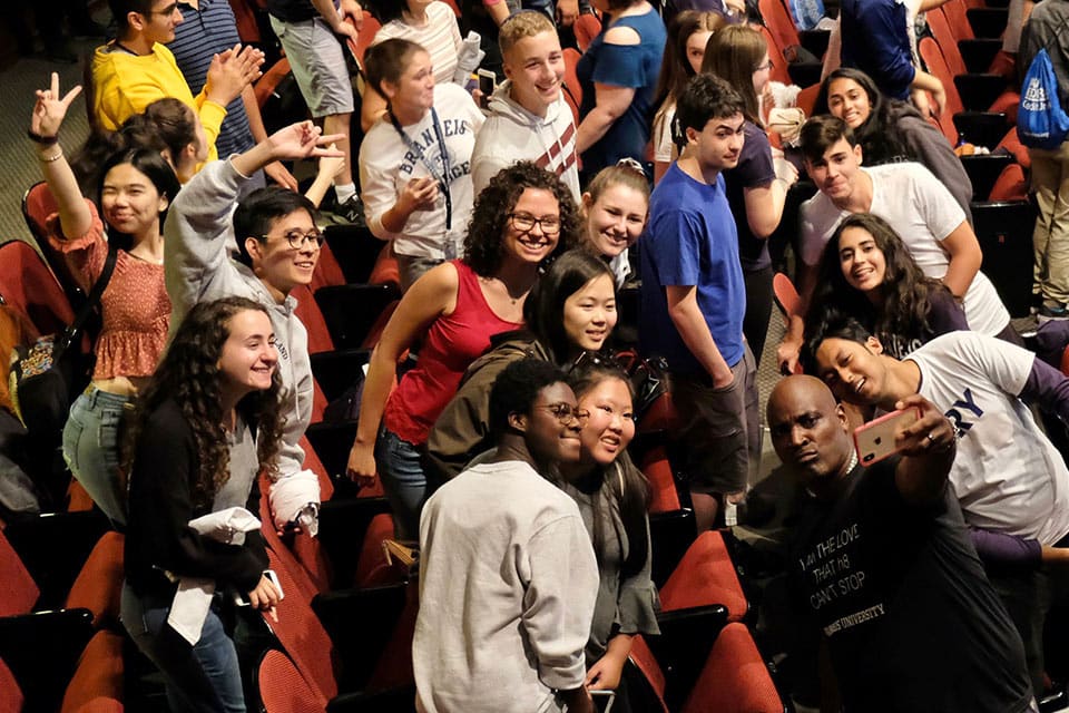 Students excitedly on stage at This Is Our House