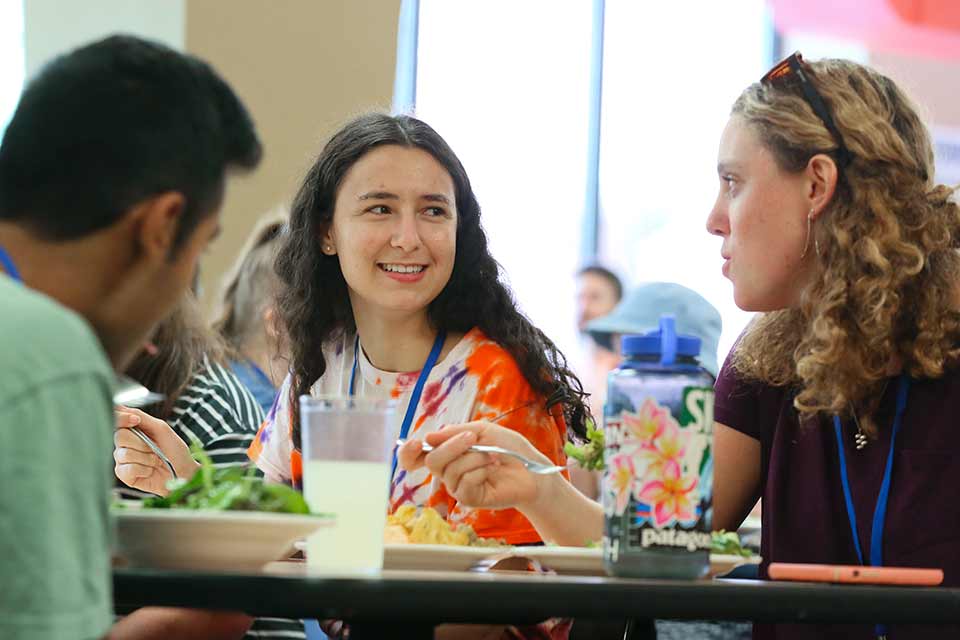 Students chat while eating in a dining hall