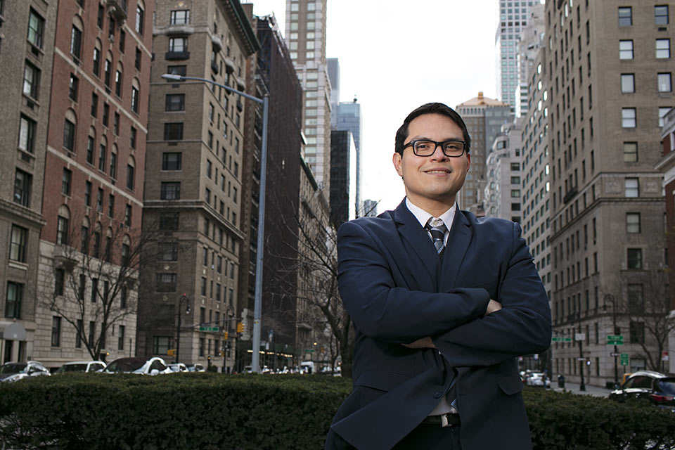 Ernie standing in the median of a New York City street with tall buildings around him