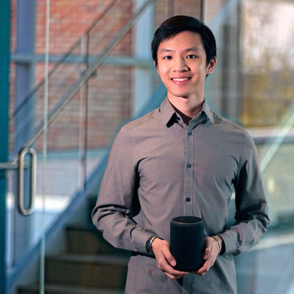 Michael Leung holds an Amazon Echo device