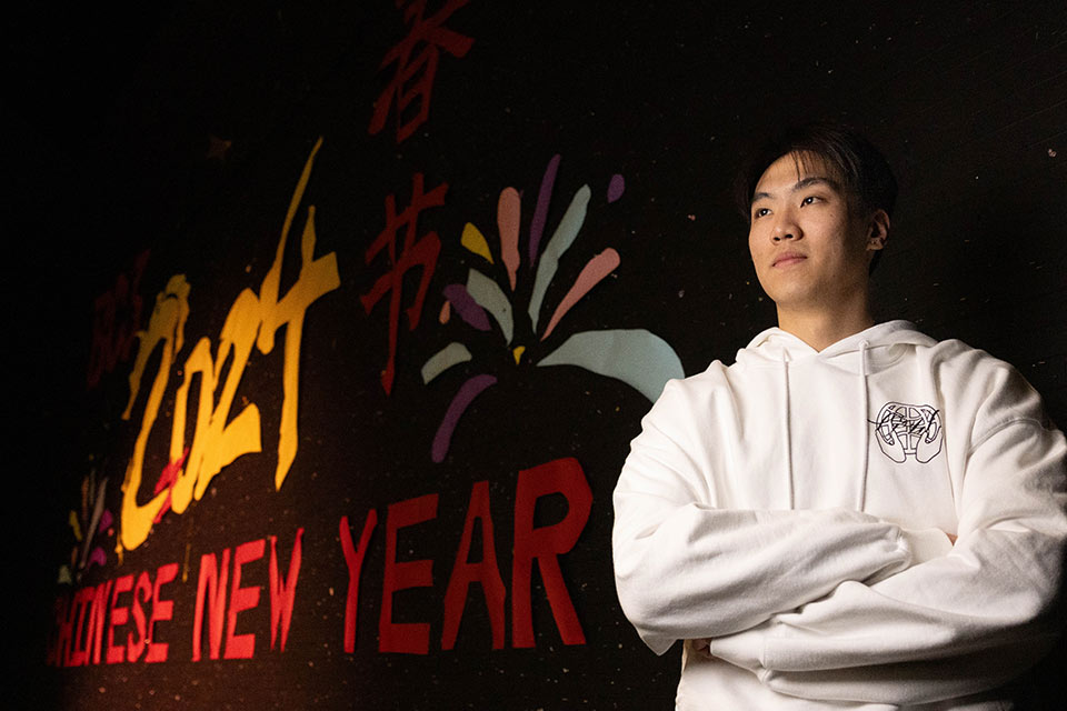 Jerry posing in front of a Lunar New Year banner