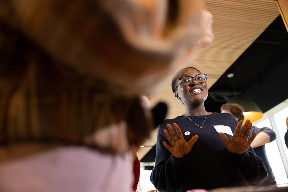 Justine speaking to people at an event