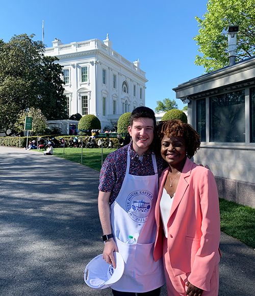 Zac posing with the Press Secretary, Karine Jean-Pierre, in front of the White House