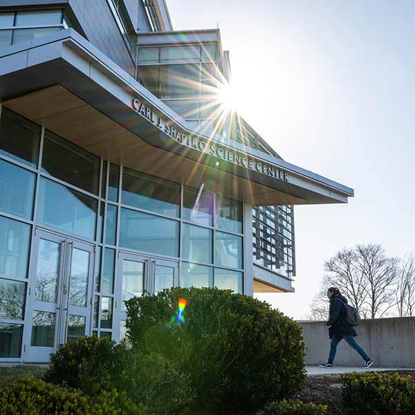 A student walks toward the Shapiro Science Center building