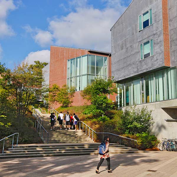 Students go up the stairs near the Village residence hall