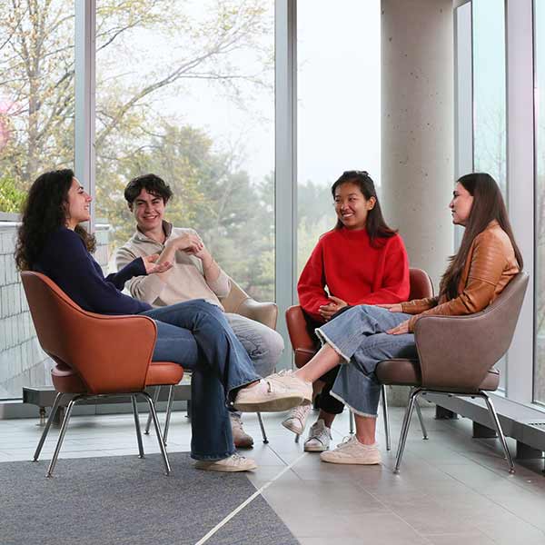 Four students sitting and talking