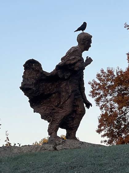 Louis Brandeis statue with a bird perched on Louie's head