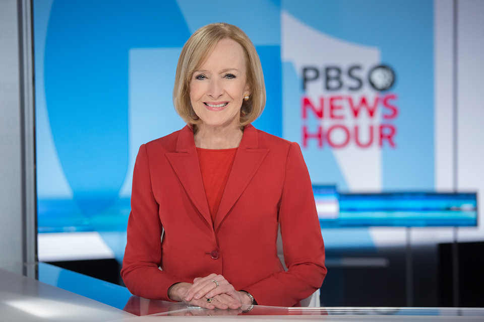 Judy Woodruff, who is being honored by the Brandeis National Committee, sits at her desk at PBS NewsHour