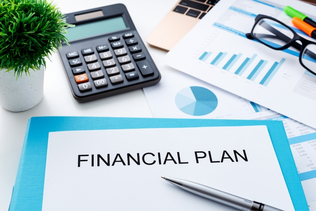Paper that says Financial Plan next to a calculator