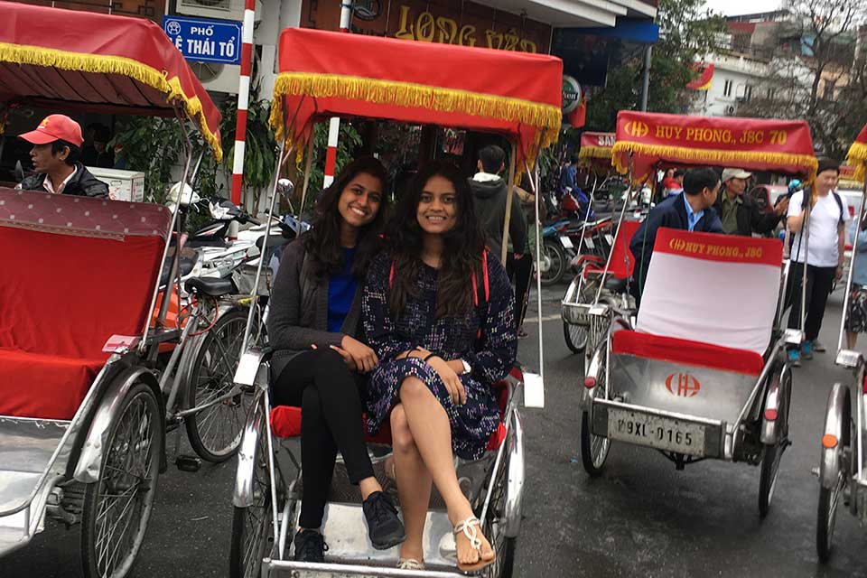 Khushee Nanavati and a friend in a pedicab in Singapore