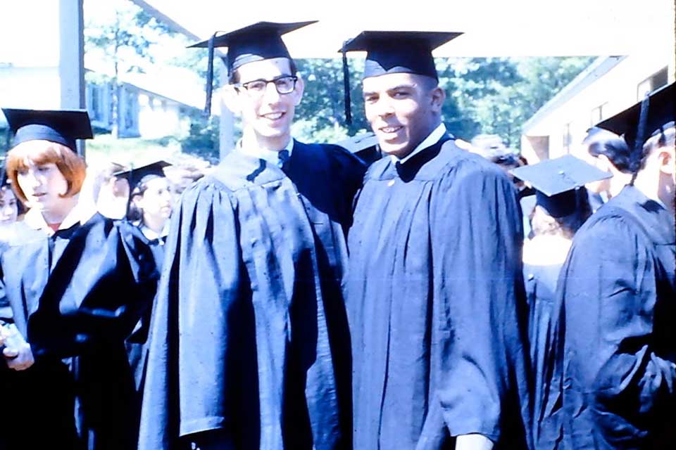 Mike Leiderman and Joe Perkins in caps and gowns at commencement in 1966.