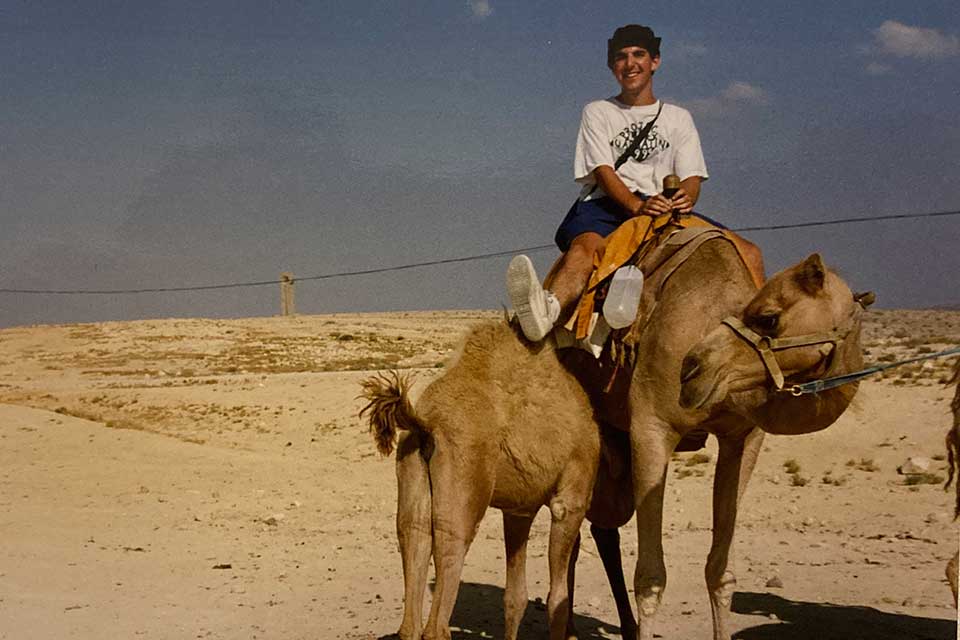 Steven Safran riding a camel in the Negev 