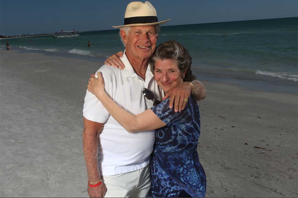 Kama Einhorn hugging her biological father on the beach.