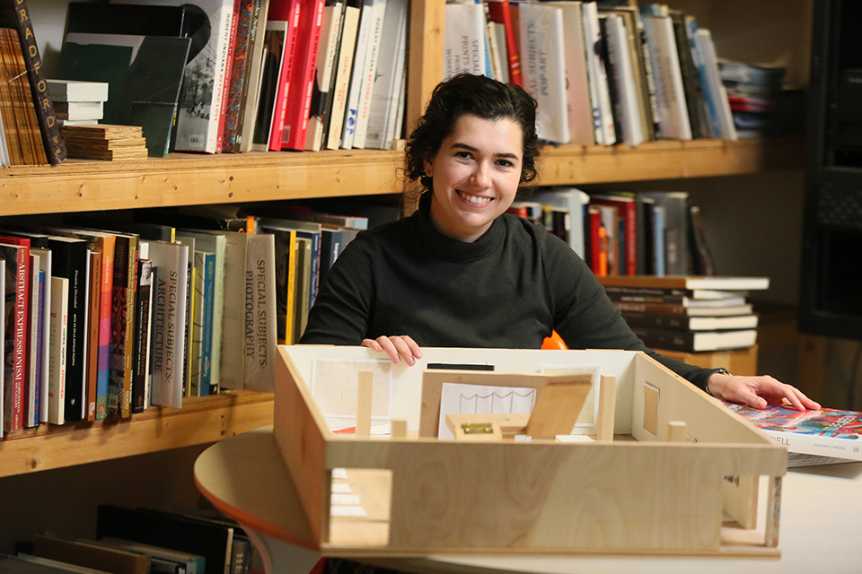 student with a box of books