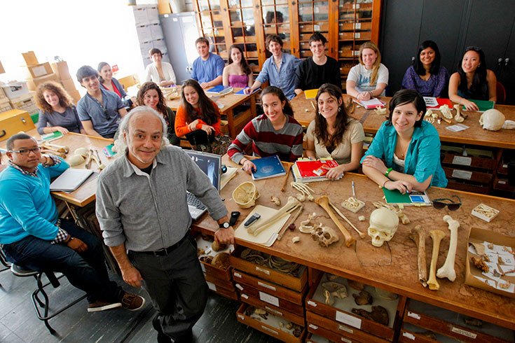 Professor Javier Urcid stands in front of his class, all smiling for the camera