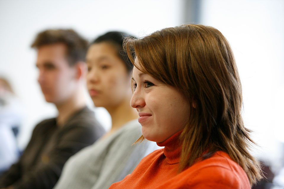 A female student smiles as she looks ahead of her