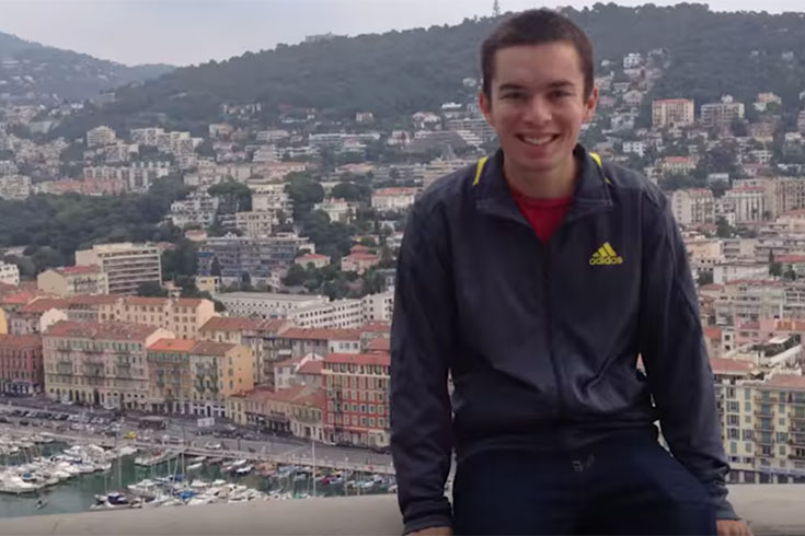 Kevin Dupont sits in front of a cityscape