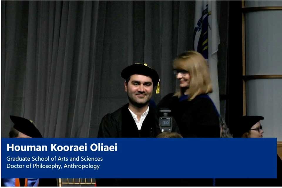 student being hooded at doctorate graduation