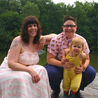 Alexis (right) with her partner and child.