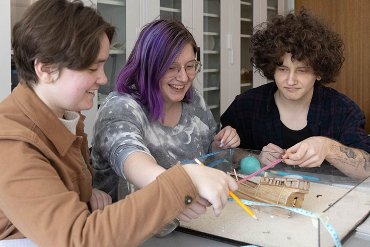 Students work on a mock shipwreck archeological excavation.