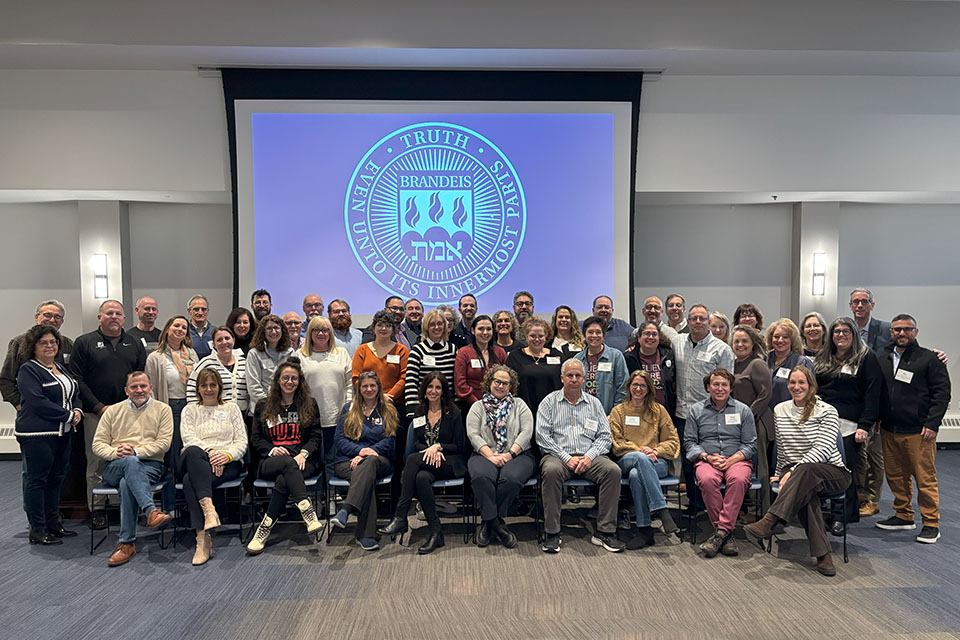 Group Photo of JCC Executives with Brandeis University  seal in background