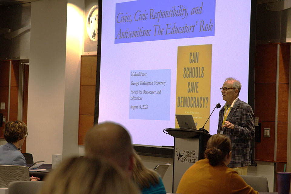 Dr. Michael Feuer speaking with slide in background titled "Civics, Civic Responsibility, and Antisemitism: The Educator's Role