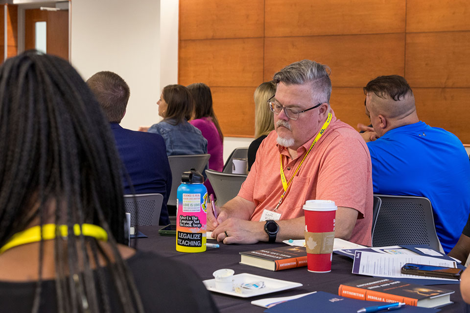 listener taking notes & colorful water bottle