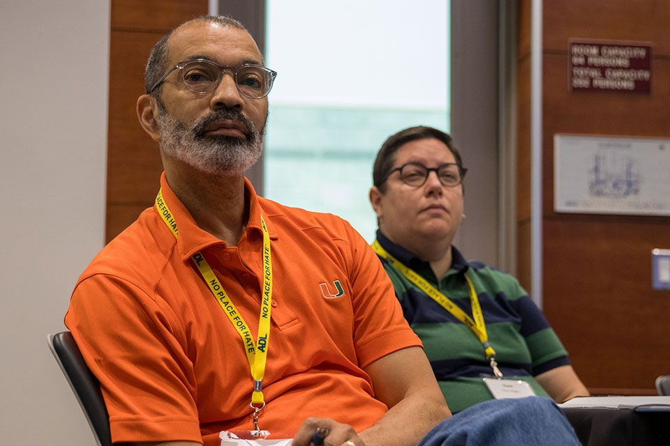 two audience members listening intently