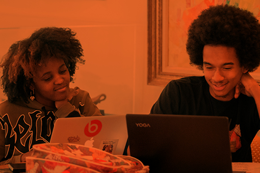 students using laptops while studying together