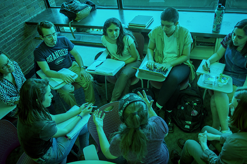 students seated in a circle during classroom discussion