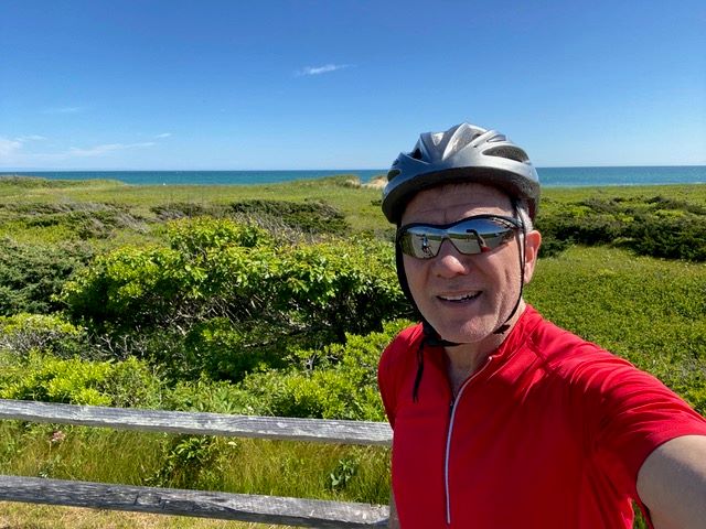 Selfie of Jeffrey with shoreline in background