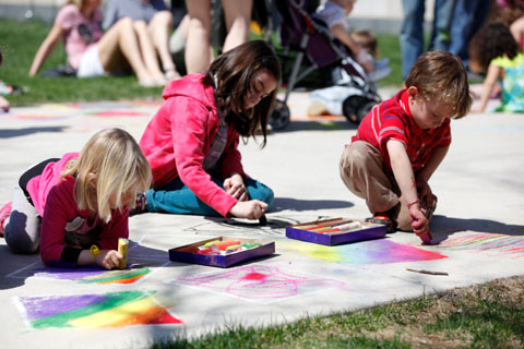 Youngsters decorating walkways with chalk.