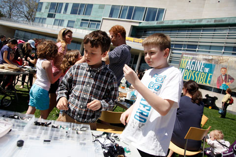 Two young boys checking out one of the tables on the Great Lawn.