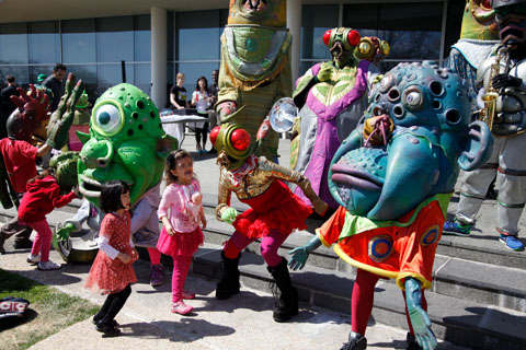 Visual performance artists Big Nazo, dressed in alien-style costumes take part in the festival.