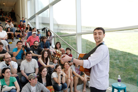 Ben Lovenheim ’15 leads a sing-along in The Rose Art Museum.