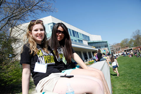 Volunteers take a break to enjoy the sun on the Great Lawn wall in front of the SCC.