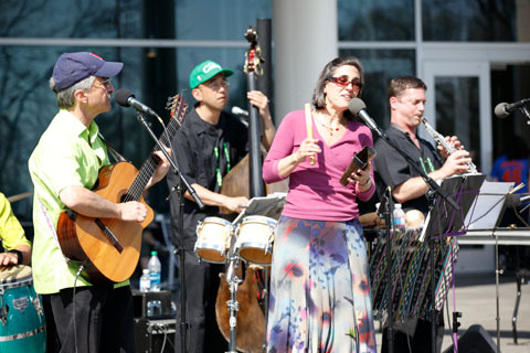 Sol y Canto performing in the bright sunlight in front of the SCC.