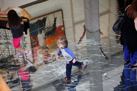 People of all ages enjoy the mirrored floor of The Rose Art Museum, which appears to crack under pressure.