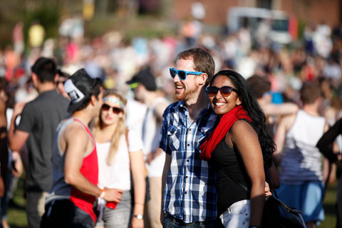 People in sunglasses enjoying the festive atmosphere.