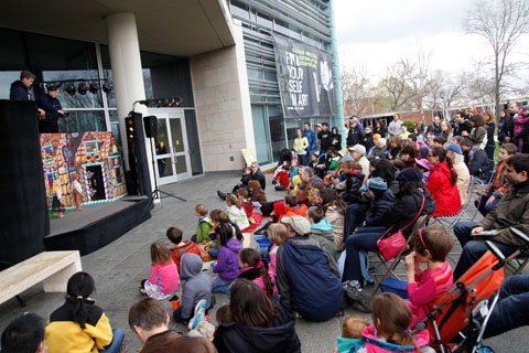 An engaged audience watching an outdoor marionette performance