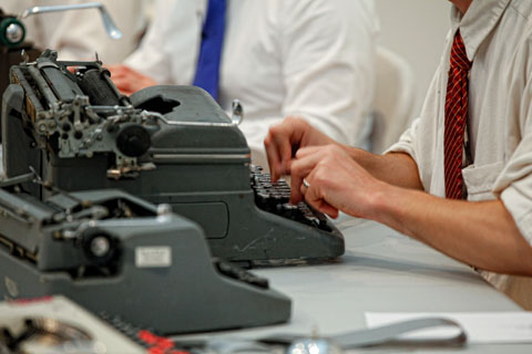 Close up of the hands of a performer from the Boston Typewriter Orchestra.