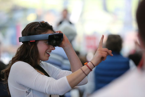 A student wearing virtual-reality headgear.