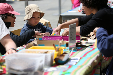 Elisa Hamilton helps a young child do a craft