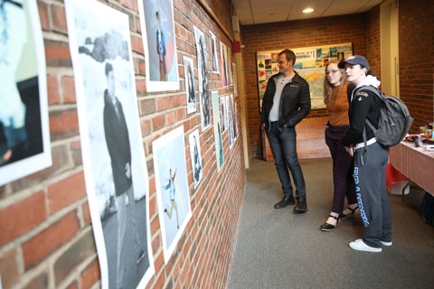 Attendees viewing images posted on the wall.
