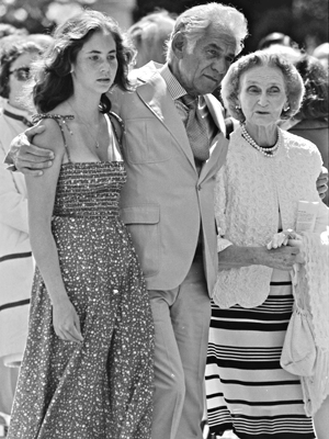 Leonard Bernstein with arms around friends, looking pensive