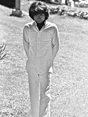 Seiji Ozawa walking, looking at grass