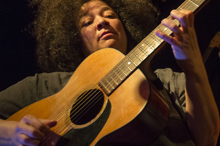 Black woman playing guitar